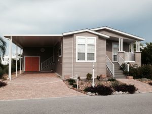 Front view of a house with a carport, stairs and a garage