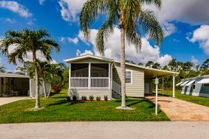 Front view of a small screen room and carport