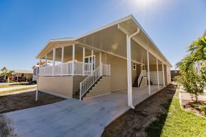 Side view of a garage with a carport and stairs