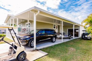 Angled view of a carport with a garage and stairs
