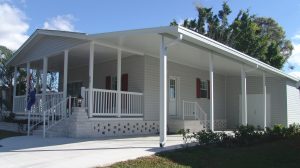 Angled view of a house with stairs and a carport