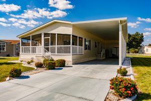 Angled view of a house with a screen room, stairs and a carport