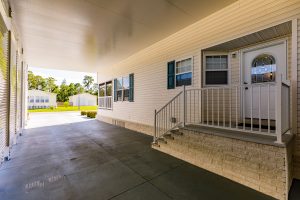 Angled view of an enclosed carport with stairs