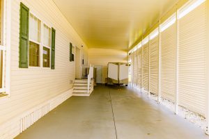 Front view of an enclosed carport and stairs