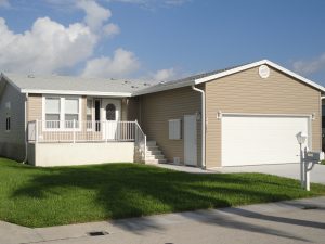 Angled view of a house with a garage and stairs