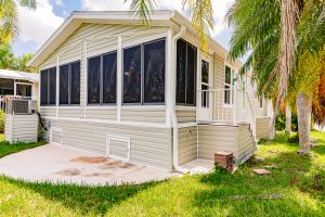 Back view of a house with a screen room and stairs