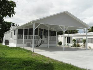 Front view of double carport with screen room and stairs