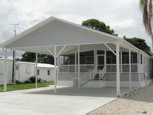 Angled view of a double carport with stairs and a screen room