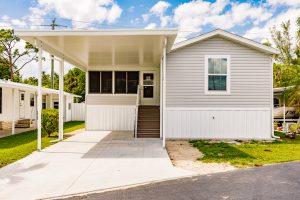 Front view of a house with stairs and a carport