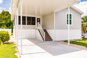 Angled view of a house with a carport and stairs