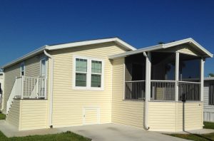 Back view of a house with a screen room and stairs