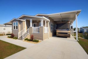 Angled view of a house with stairs and an RV port