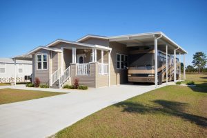 Angled view of a house with an RV port and stairs