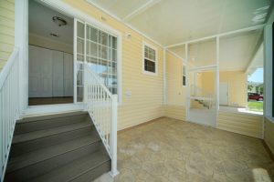 A view inside a porch with stairs and a shed